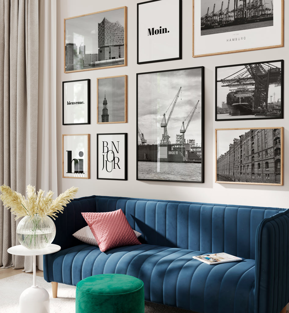 blue sofa for gallery wall with various Hamburg prints in black white